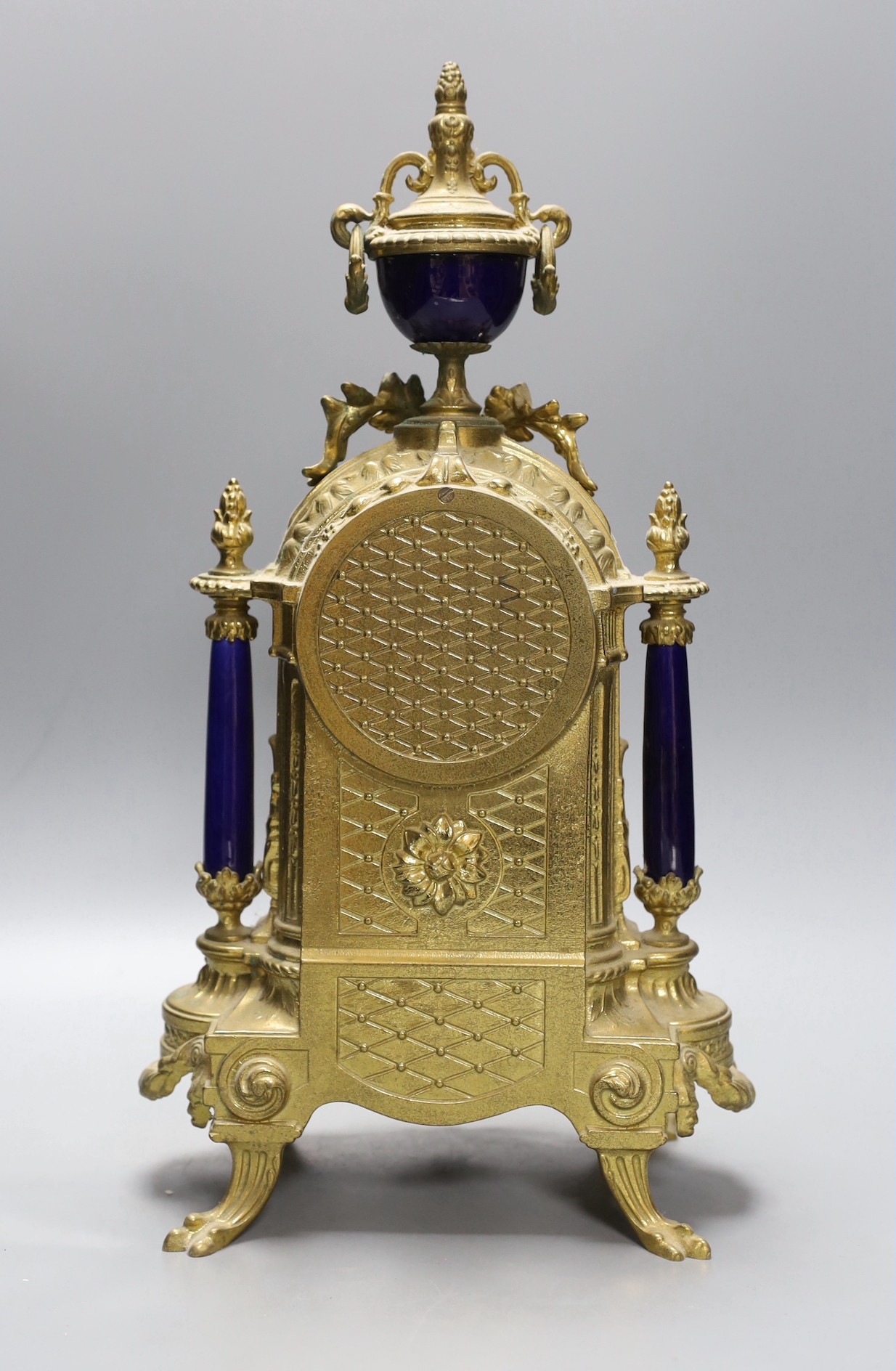 A ornamental gilt French mantel clock with painted porcelain insets - 41.5cm tall